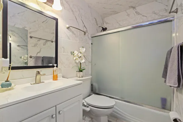 a bathroom with a sink toilet and shower