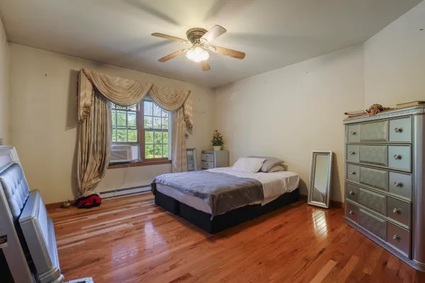 a bedroom with a bed and a flat tv screen