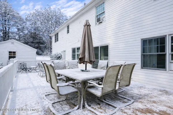 a view of a patio with a table and chairs