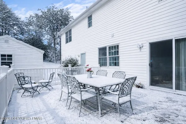 a backyard of a house with table and chairs