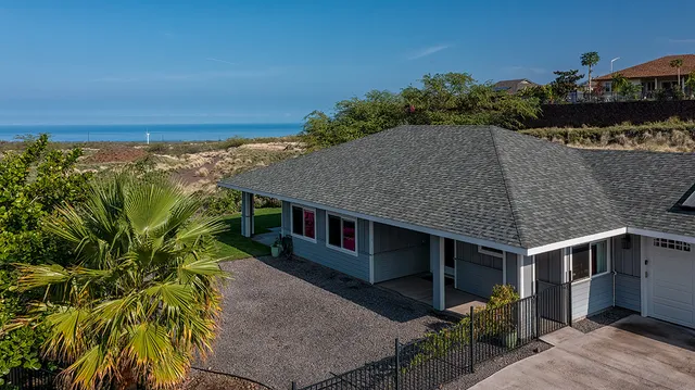 a aerial view of a house with a yard