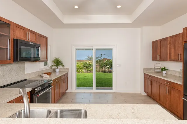a kitchen with stainless steel appliances granite countertop a stove and a sink