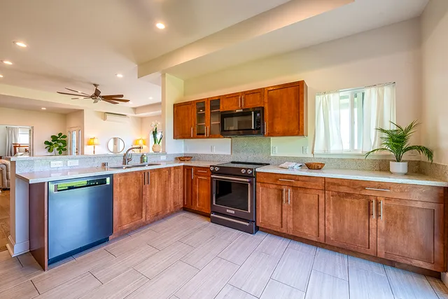a kitchen with stainless steel appliances granite countertop a stove and a sink