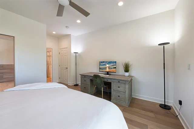 a bedroom with a bed and a desk