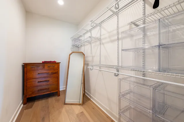 a view of walk in closet with empty racks