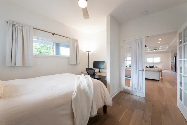 a bedroom with a bed and a view of kitchen