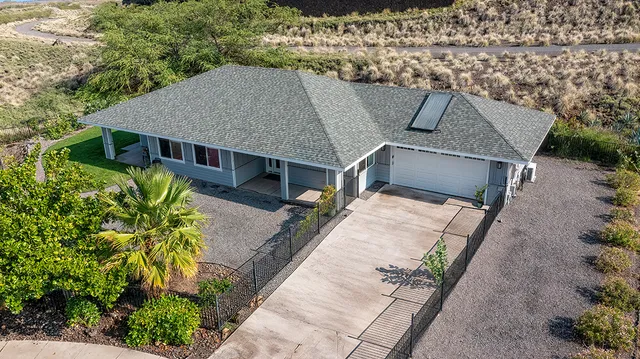 an aerial view of a house with a yard and potted plants