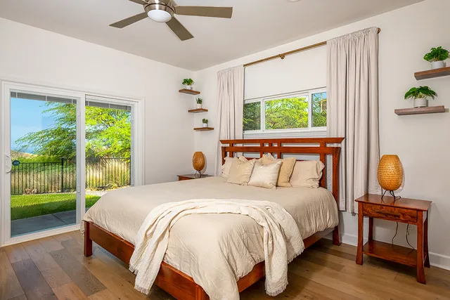 a bedroom with a bed lamp and window