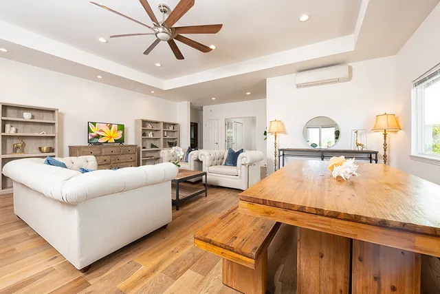 a living room with furniture and a chandelier