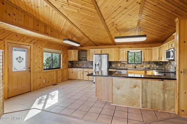 a bathroom with a granite countertop sink a toilet and shower