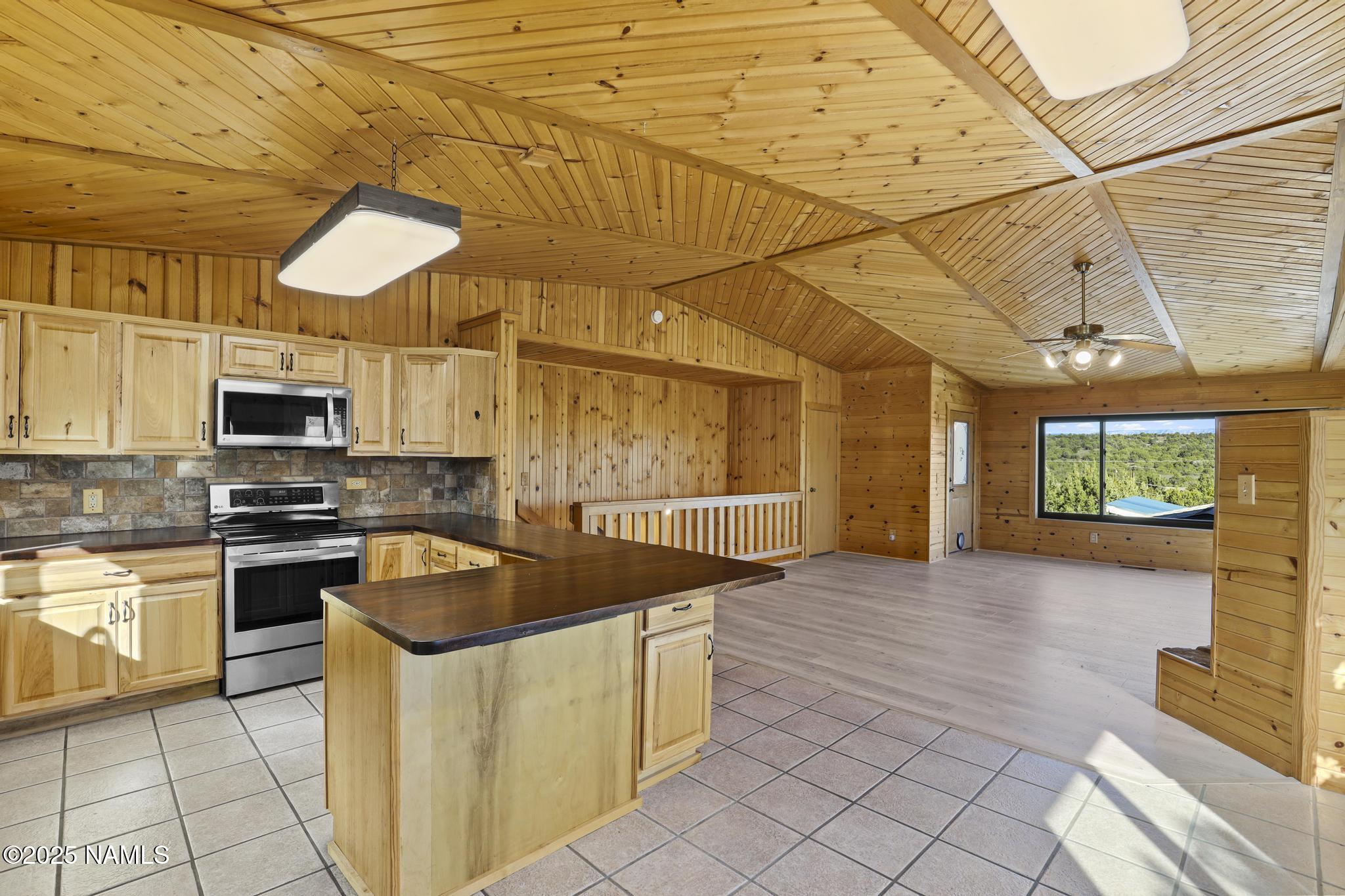 801 North Madison Drive Payson, AZ 85541 - Photo 19 of 50 a kitchen with stainless steel appliances granite countertop a sink a stove and cabinets