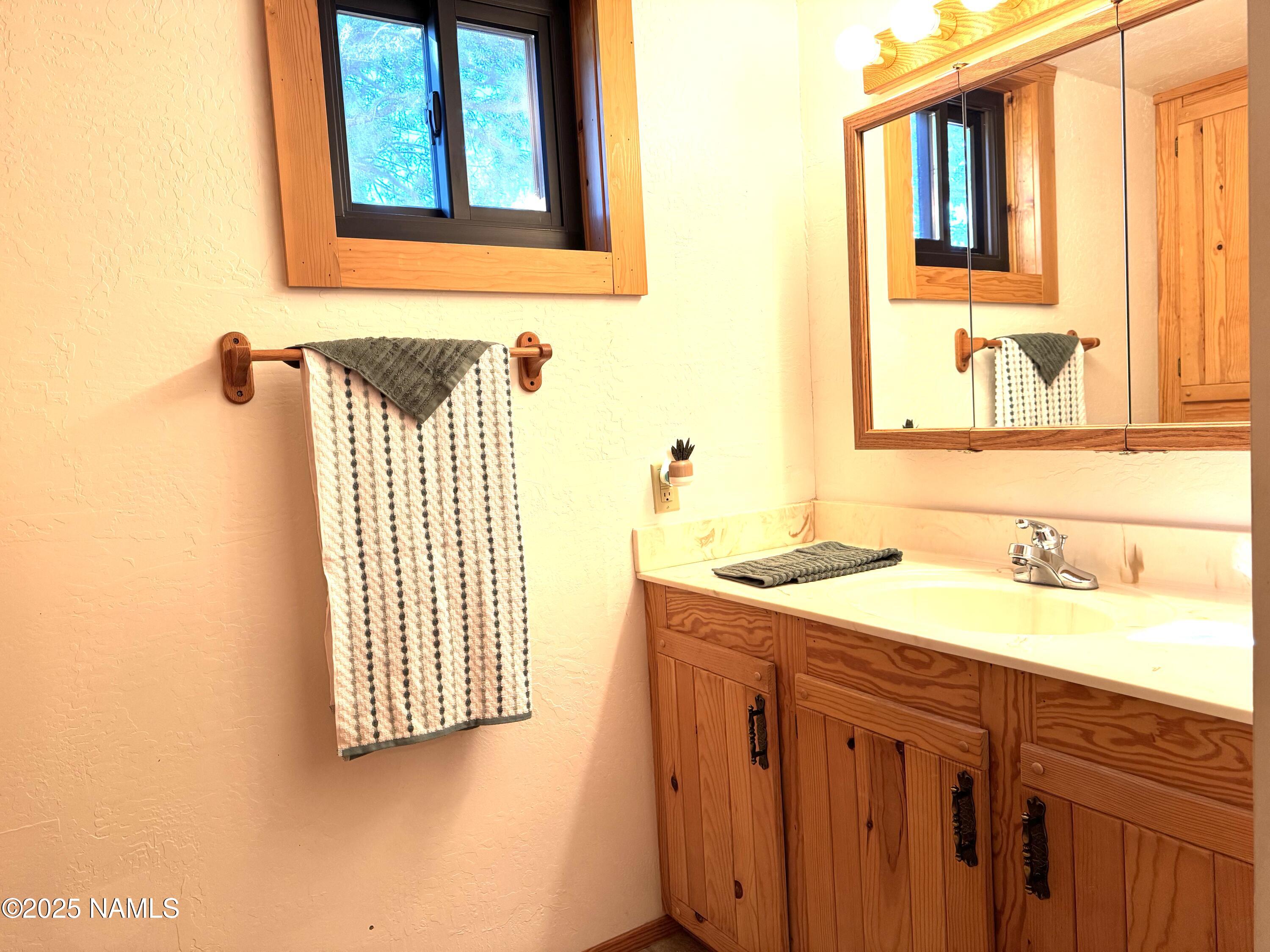 801 North Madison Drive Payson, AZ 85541 - Photo 38 of 50 a bathroom with a sink and a mirror