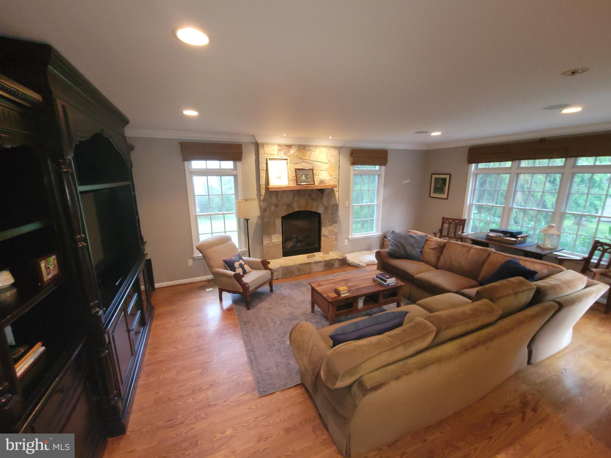 2424 Stanwick Road Phoenix, MD 21131 - Photo 17 of 67 a living room with furniture fireplace and large windows