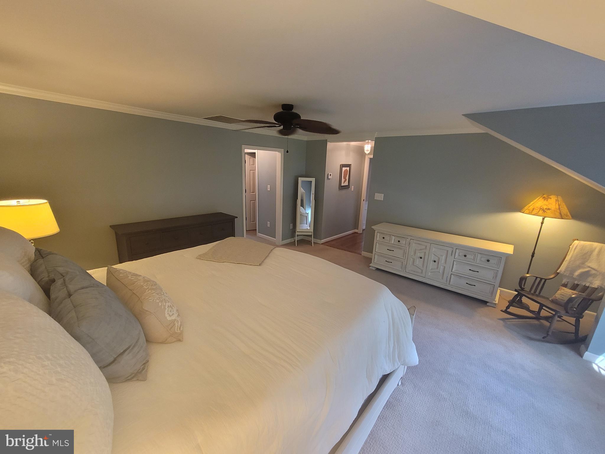 2424 Stanwick Road Phoenix, MD 21131 - Photo 32 of 67 a spacious bedroom with a bed and a lamp