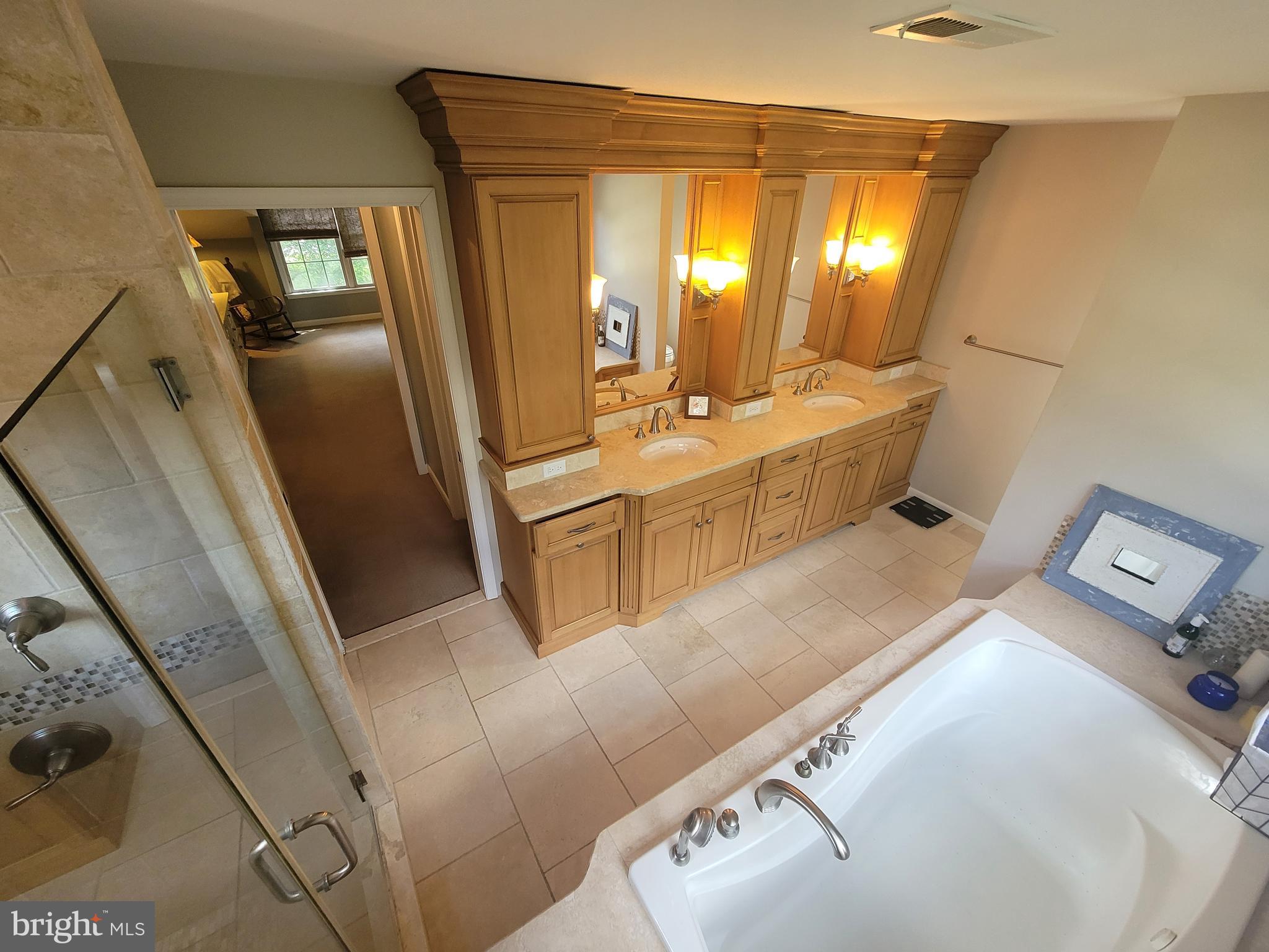 2424 Stanwick Road Phoenix, MD 21131 - Photo 36 of 67 a large bathroom with a double vanity sink and a mirror
