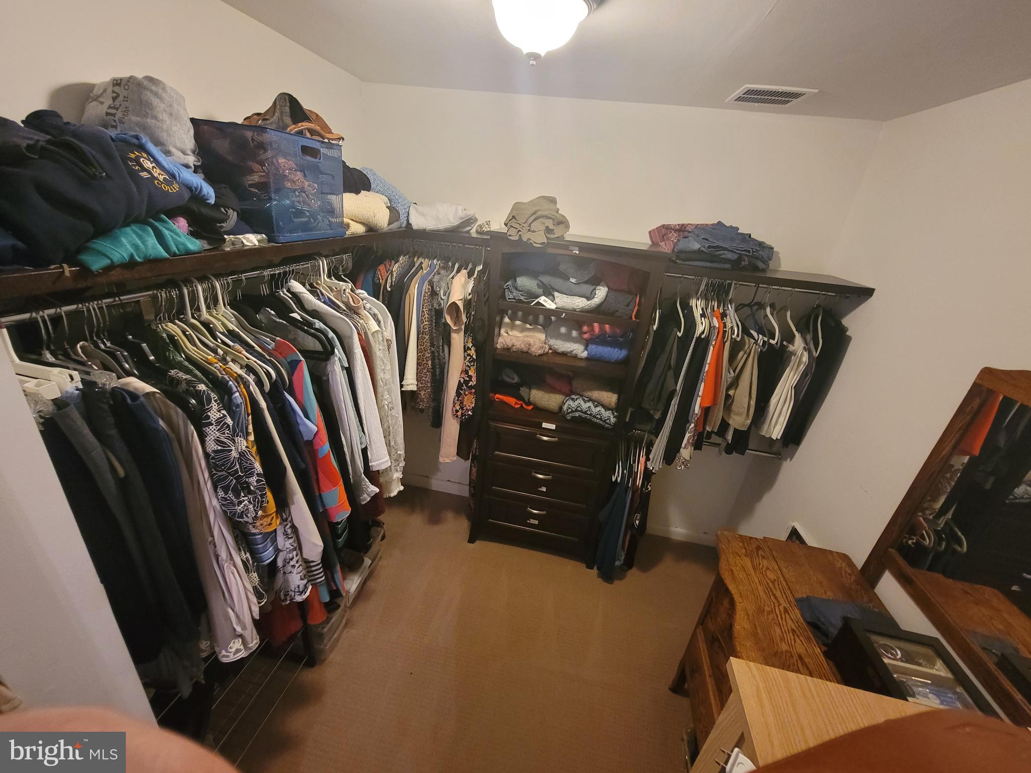 2424 Stanwick Road Phoenix, MD 21131 - Photo 40 of 67 a view of walk in closet with clothes and shoes
