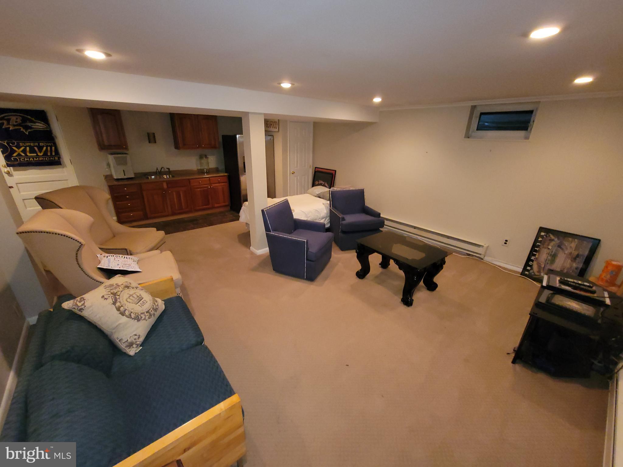 2424 Stanwick Road Phoenix, MD 21131 - Photo 54 of 67 a living room with furniture and a flat screen tv