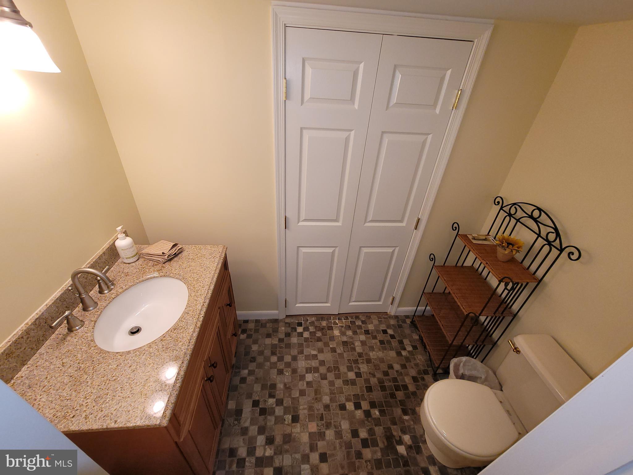 2424 Stanwick Road Phoenix, MD 21131 - Photo 56 of 67 a bathroom with a granite countertop sink and a mirror