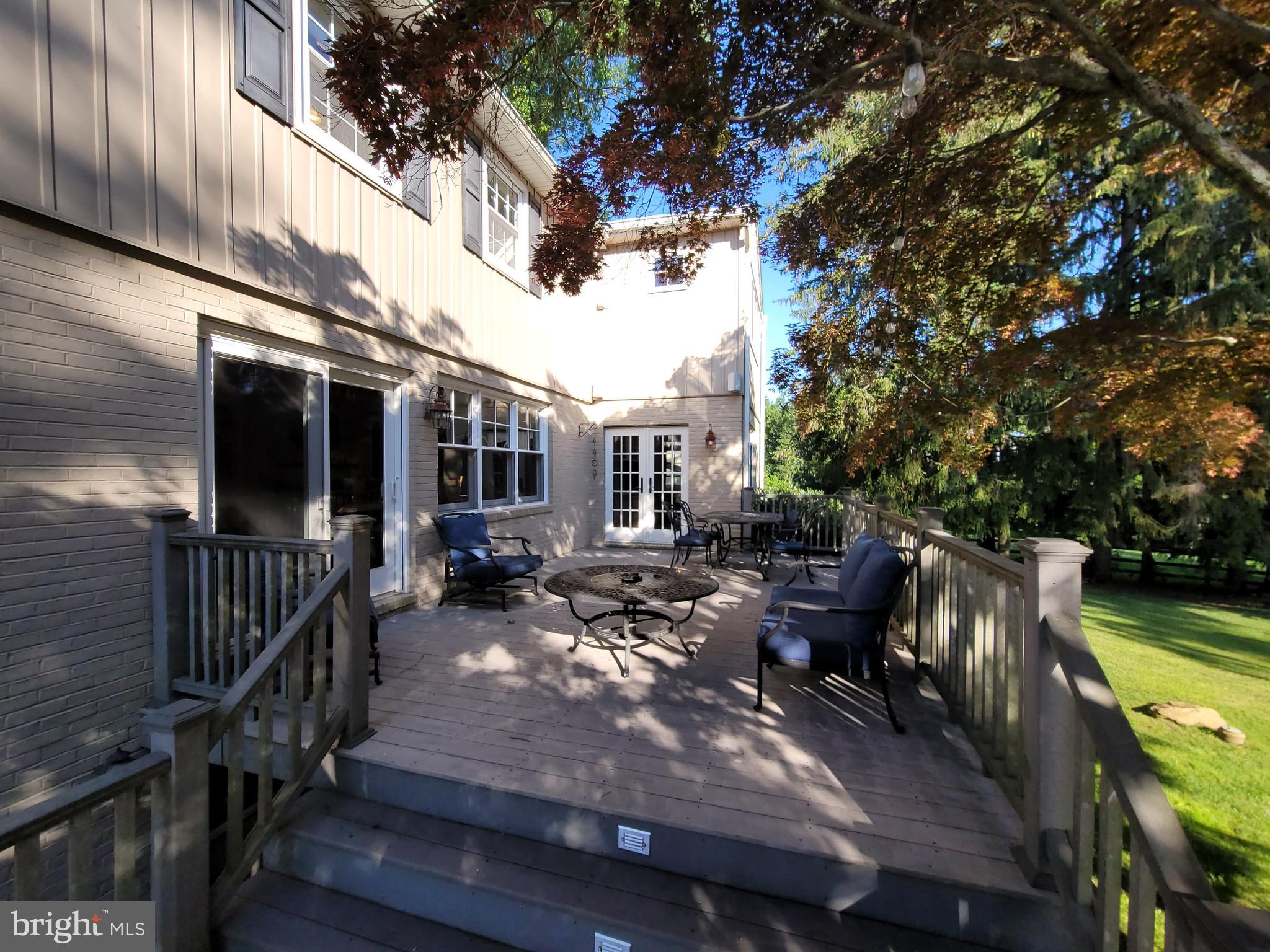 2424 Stanwick Road Phoenix, MD 21131 - Photo 66 of 67 a view of a patio with couches table and chairs and potted plants with wooden floor and fence