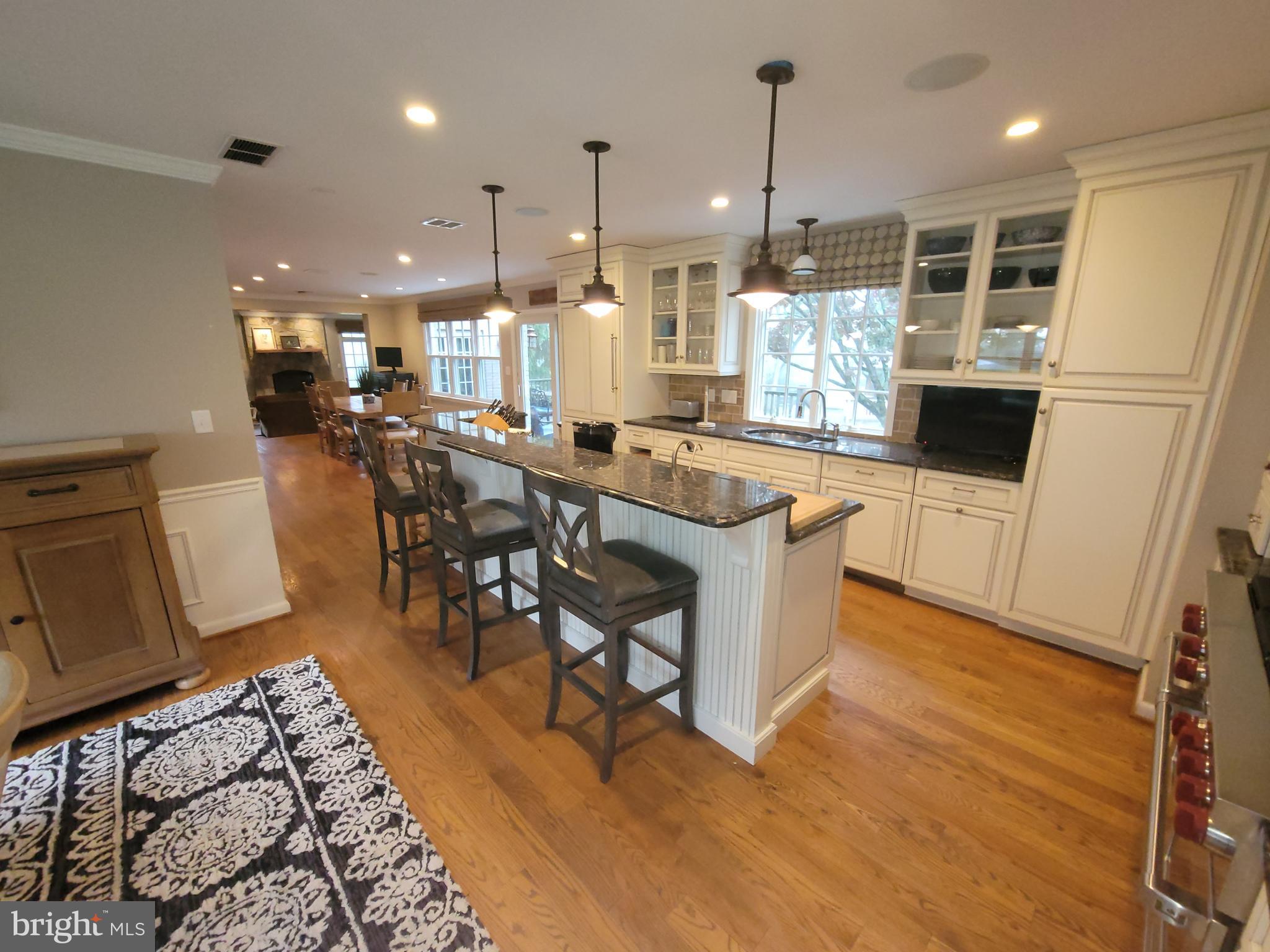 2424 Stanwick Road Phoenix, MD 21131 - Photo 9 of 67 a kitchen with stainless steel appliances granite countertop a refrigerator a oven a sink a dining table and chairs with wooden floor