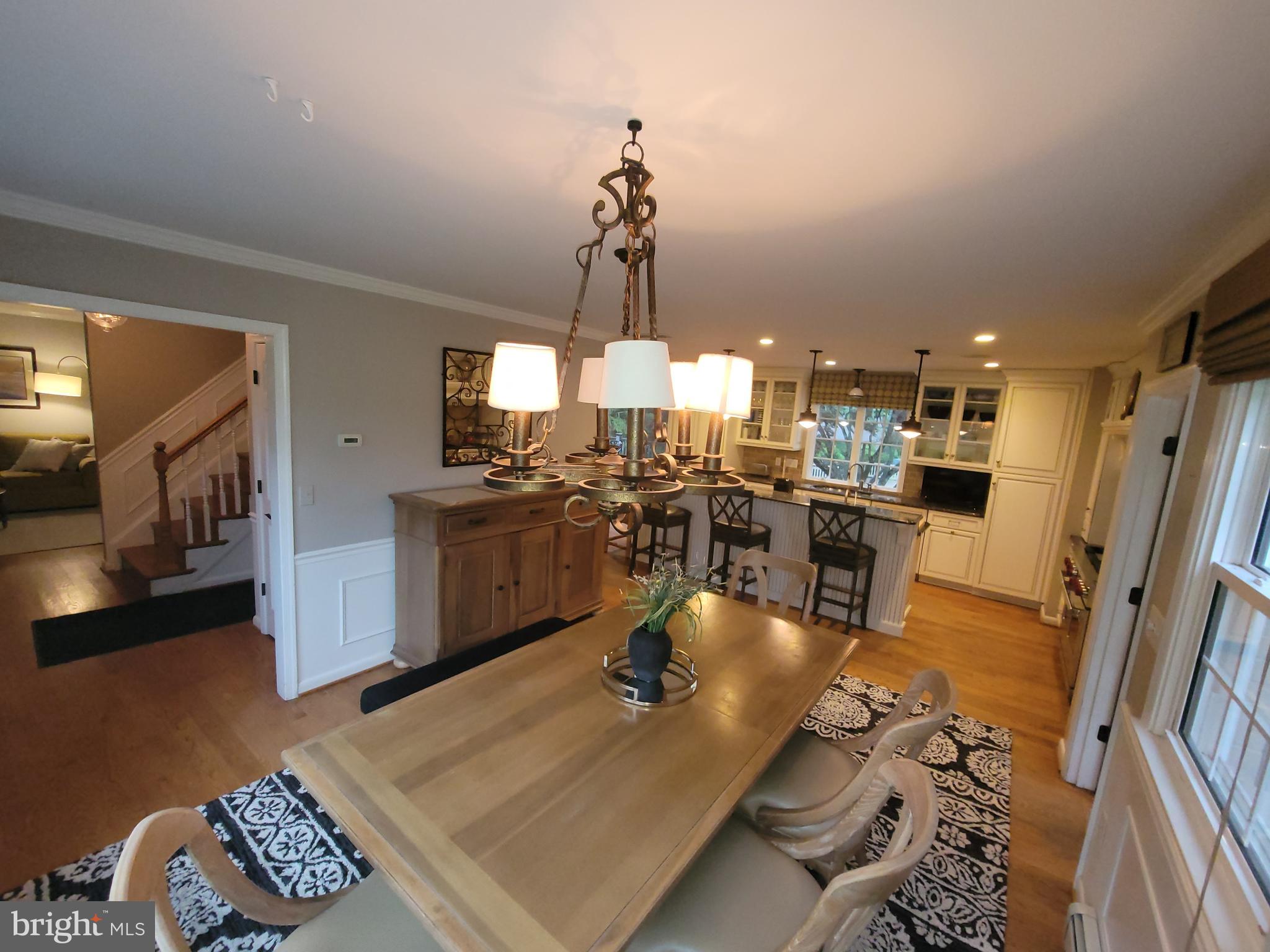 2424 Stanwick Road Phoenix, MD 21131 - Photo 10 of 67 a kitchen with stainless steel appliances granite countertop a sink dishwasher a stove a dining table and chairs with wooden floor