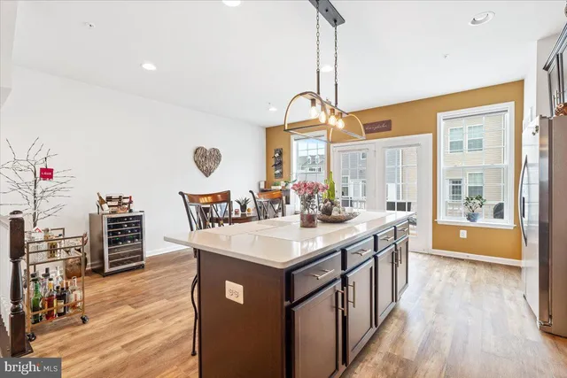 a kitchen with a stove and a wooden floor