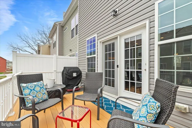 a backyard of a house with barbeque oven table and chairs