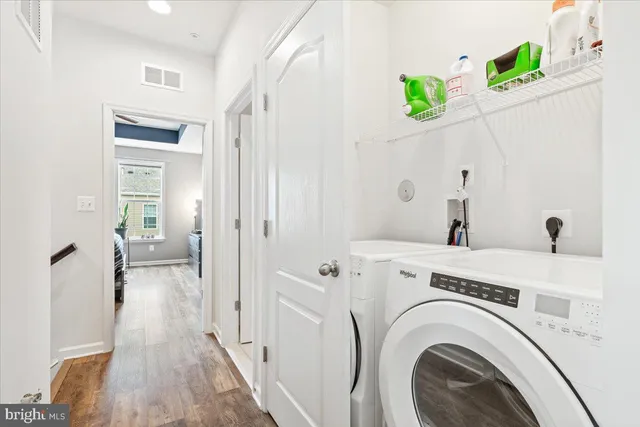 a view of a hallway with washer and dryer