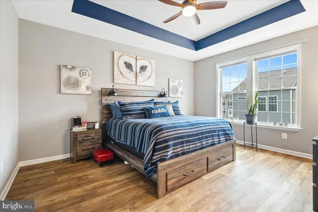 a spacious bedroom with a bed and a large window with the outer view