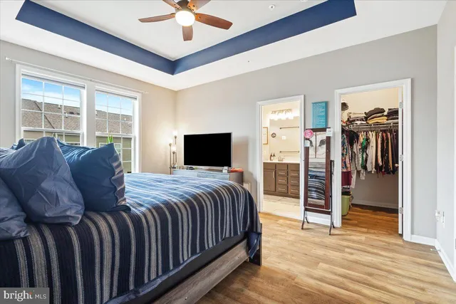 a spacious bedroom with a bed and a walk in closet