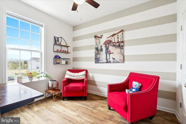 a view of a workspace with furniture and wooden floor
