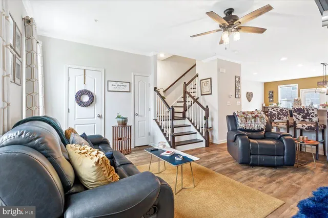 a living room with furniture ceiling fan and a rug