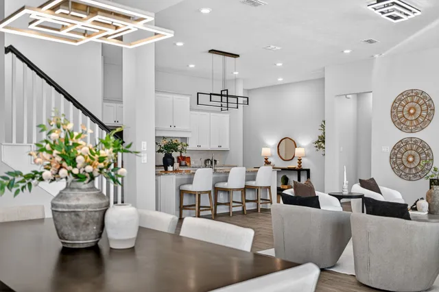 a living room with fireplace furniture and a chandelier