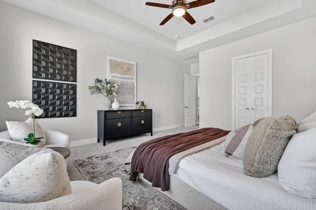 a bedroom with a bed couches and wooden floor