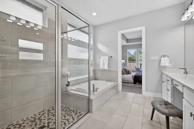 a bathroom with a tub shower and sink