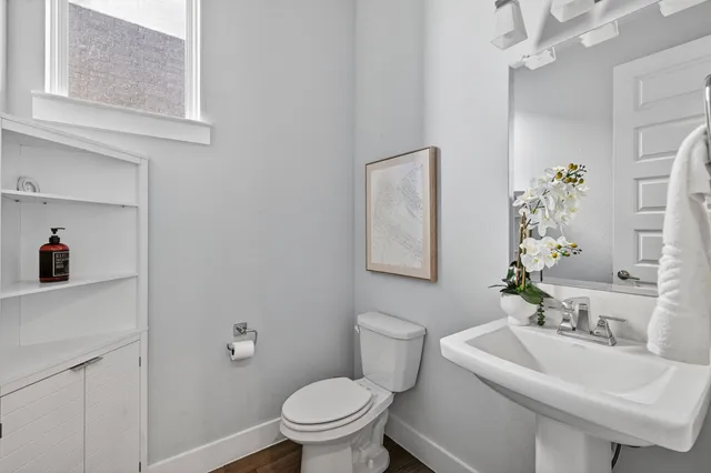 a bathroom with a sink toilet and a mirror