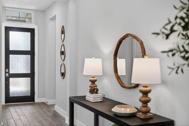 a room with wooden floor and a mirror