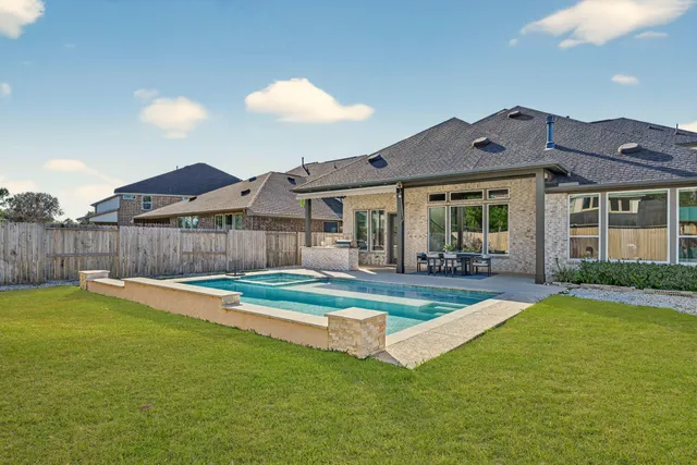 a view of house with yard and outdoor seating