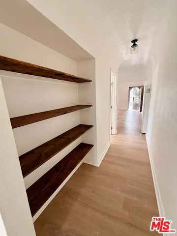 a view of a room with wooden floor