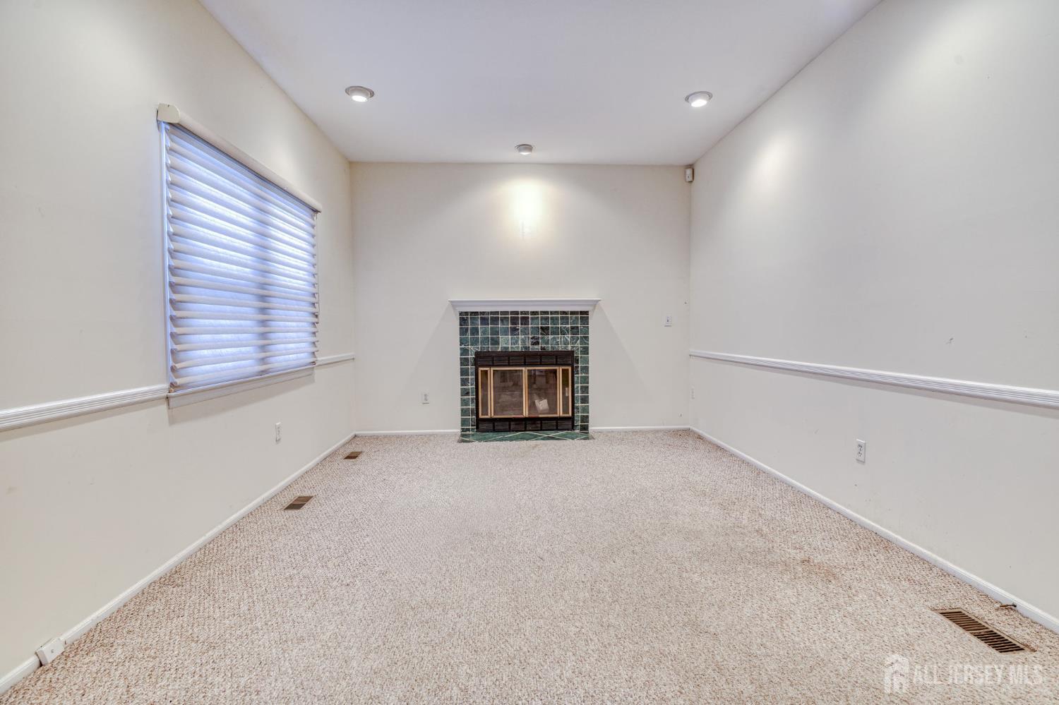 61 Ochs Avenue Milltown, NJ 08850 - Photo 11 of 29 a view of an empty room with a window and fireplace