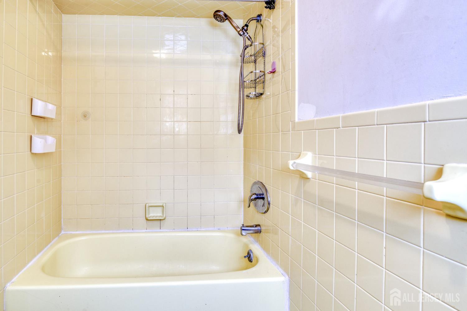 61 Ochs Avenue Milltown, NJ 08850 - Photo 17 of 29 a bathroom with a bathtub