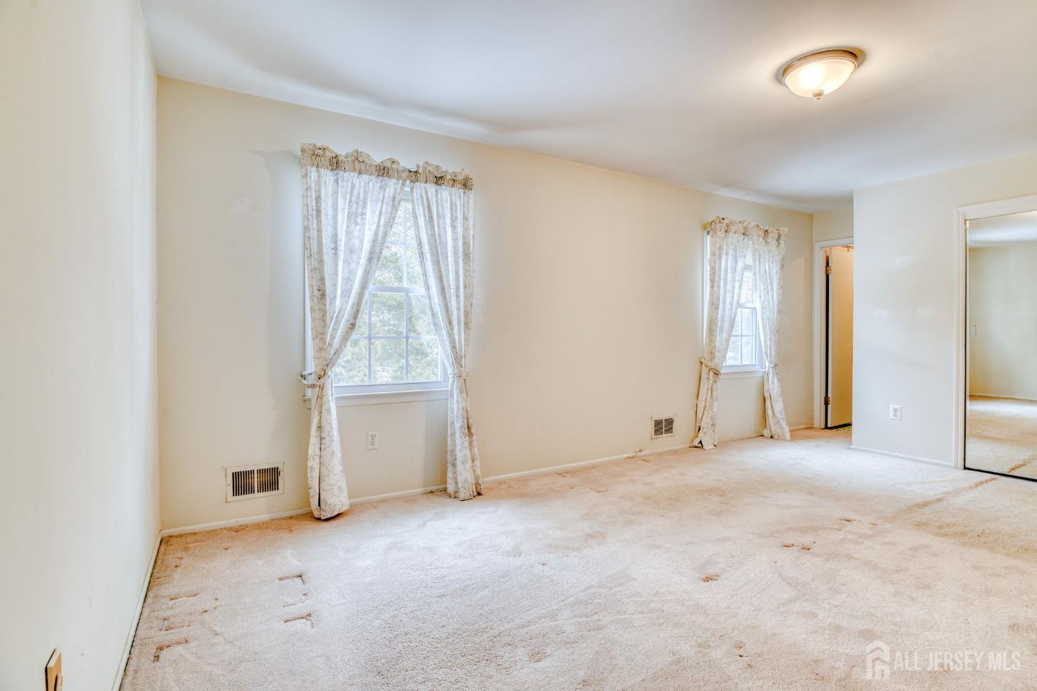 61 Ochs Avenue Milltown, NJ 08850 - Photo 21 of 29 an empty room with a empty space and windows