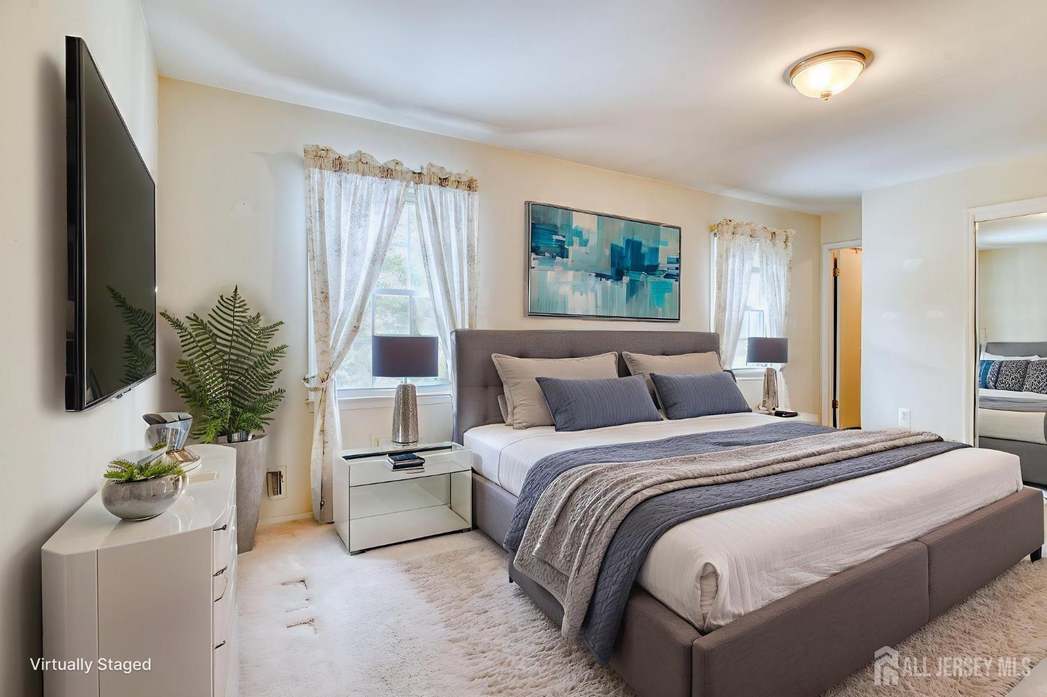 61 Ochs Avenue Milltown, NJ 08850 - Photo 23 of 29 a bedroom with a large bed and a potted plant