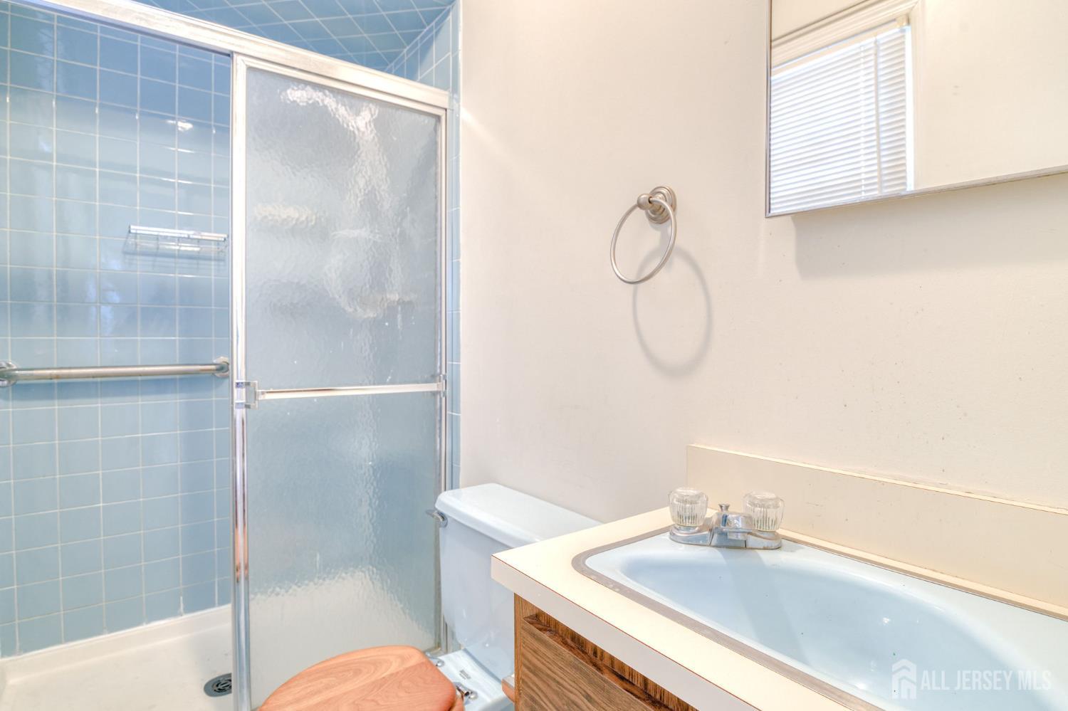 61 Ochs Avenue Milltown, NJ 08850 - Photo 24 of 29 a bathroom with a sink and a mirror