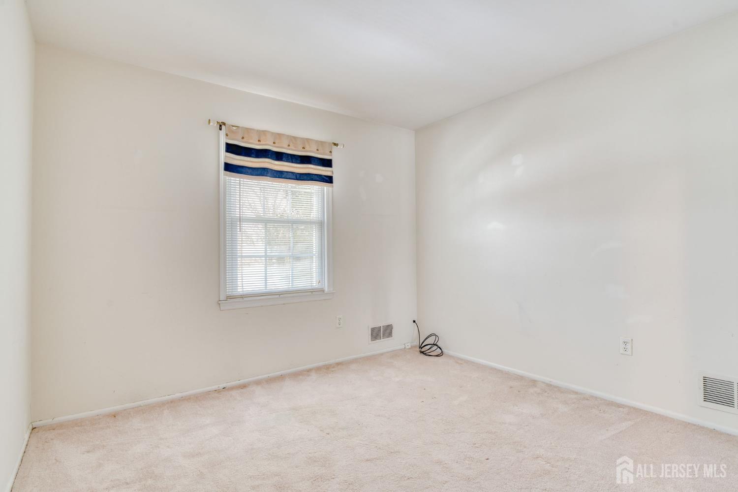 61 Ochs Avenue Milltown, NJ 08850 - Photo 25 of 29 an empty room with windows