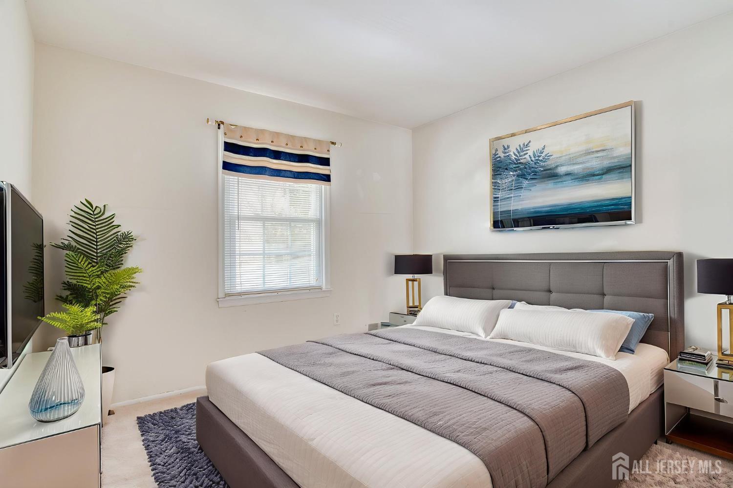 61 Ochs Avenue Milltown, NJ 08850 - Photo 26 of 29 a bedroom with bed and a potted plant