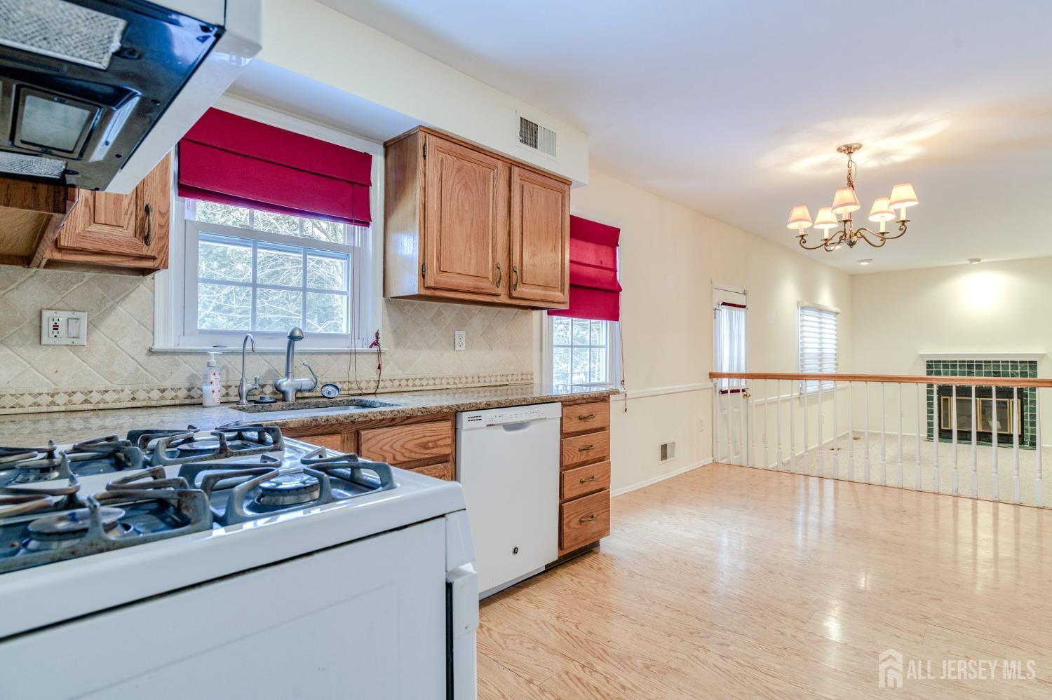 61 Ochs Avenue Milltown, NJ 08850 - Photo 7 of 29 a kitchen with stainless steel appliances granite countertop a sink stove and cabinets