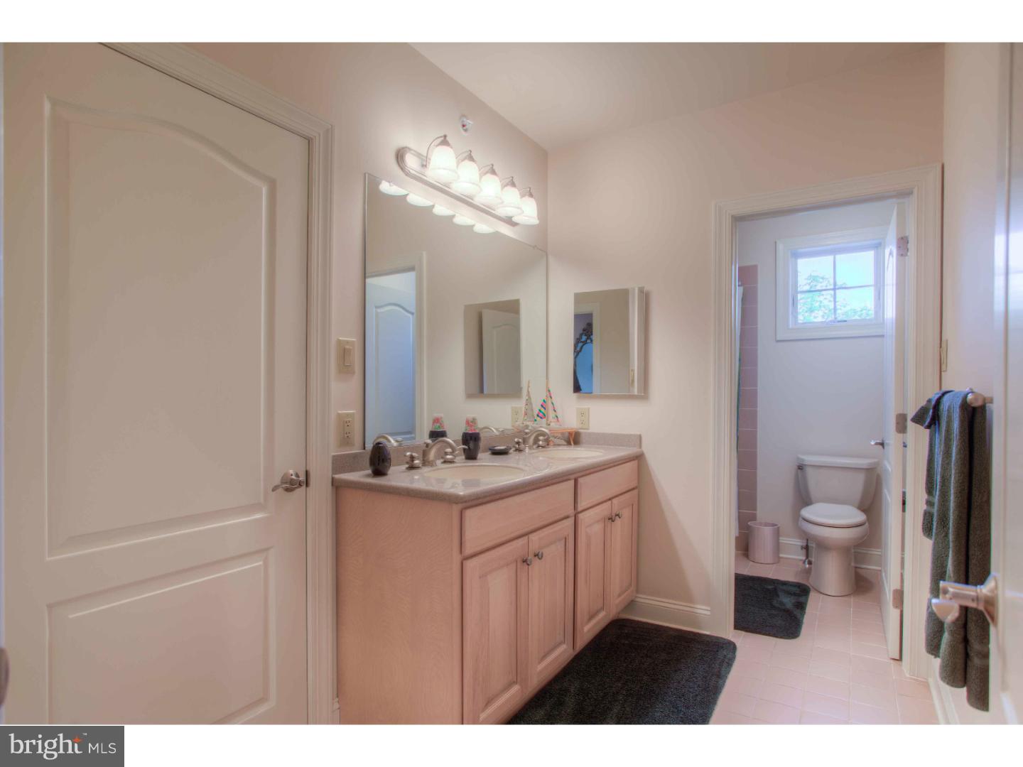 1033 Whitegate Road Wayne, PA 19087 - Photo 16 of 23 a bathroom with a toilet sink and mirror