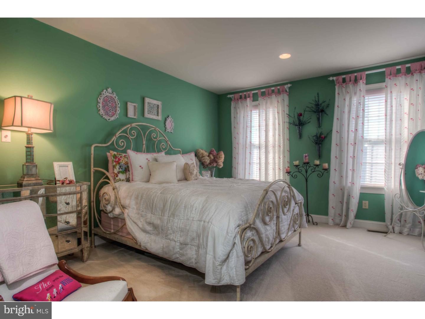 1033 Whitegate Road Wayne, PA 19087 - Photo 17 of 23 a spacious bedroom with a bed a mirror and a window