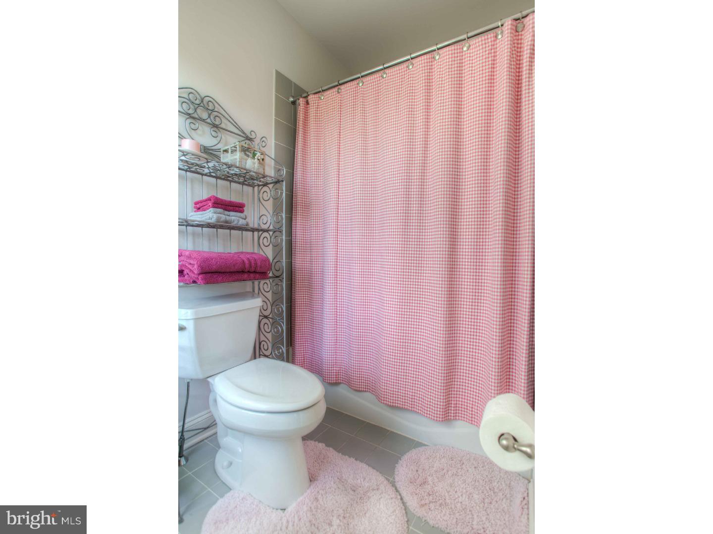 1033 Whitegate Road Wayne, PA 19087 - Photo 18 of 23 a bathroom with a toilet and a shower curtain